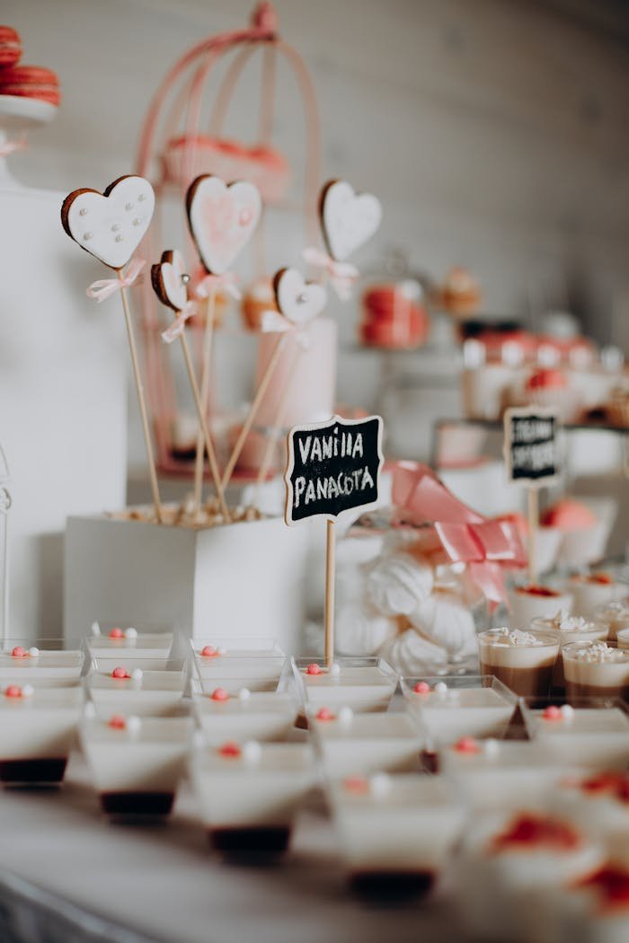 get-in-touch A beautifully arranged dessert table with vanilla panna cotta and heart-shaped sweets.
