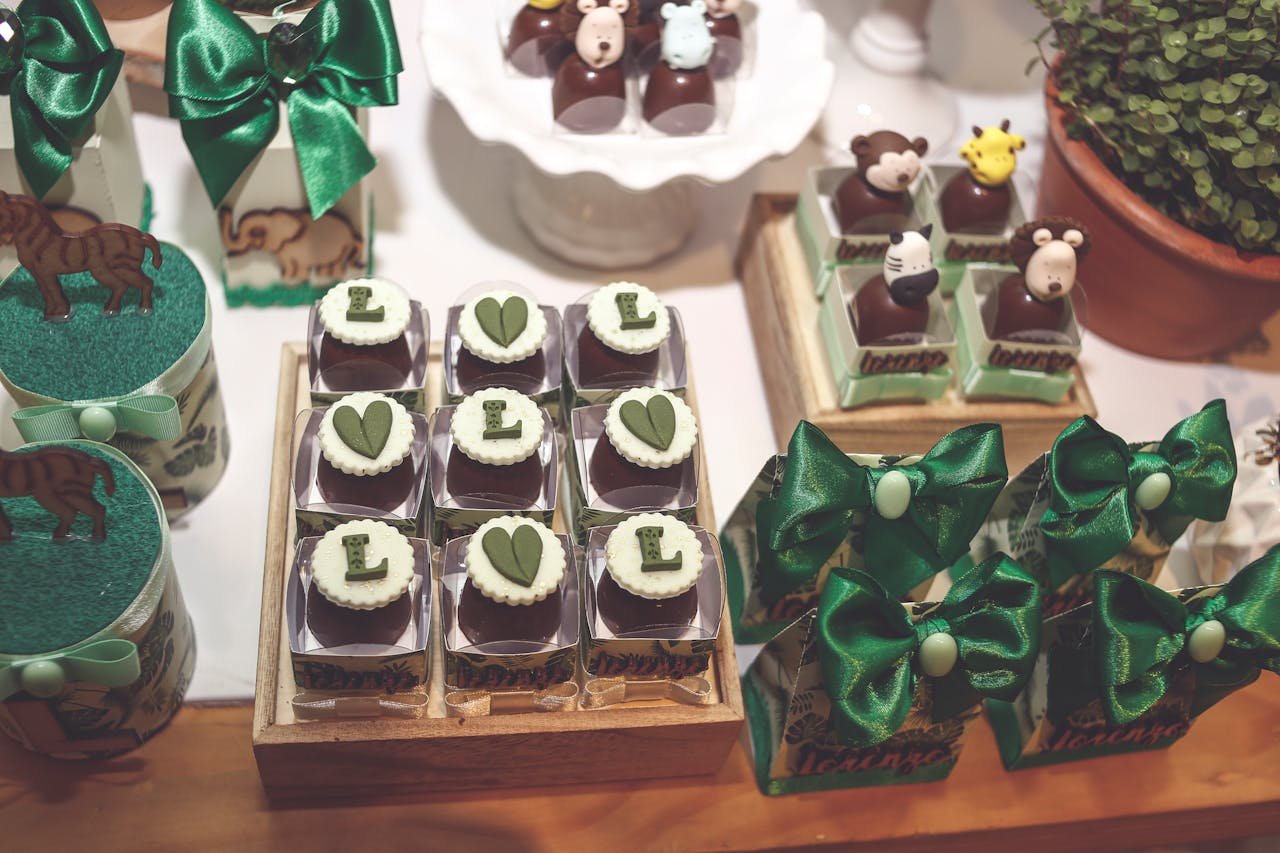 Adorable animal-themed chocolates and sweets on a decorated dessert table.