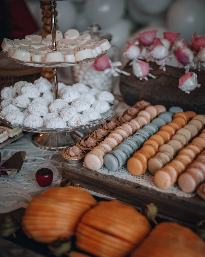A beautifully arranged dessert table featuring diverse macarons in a luxurious setting.